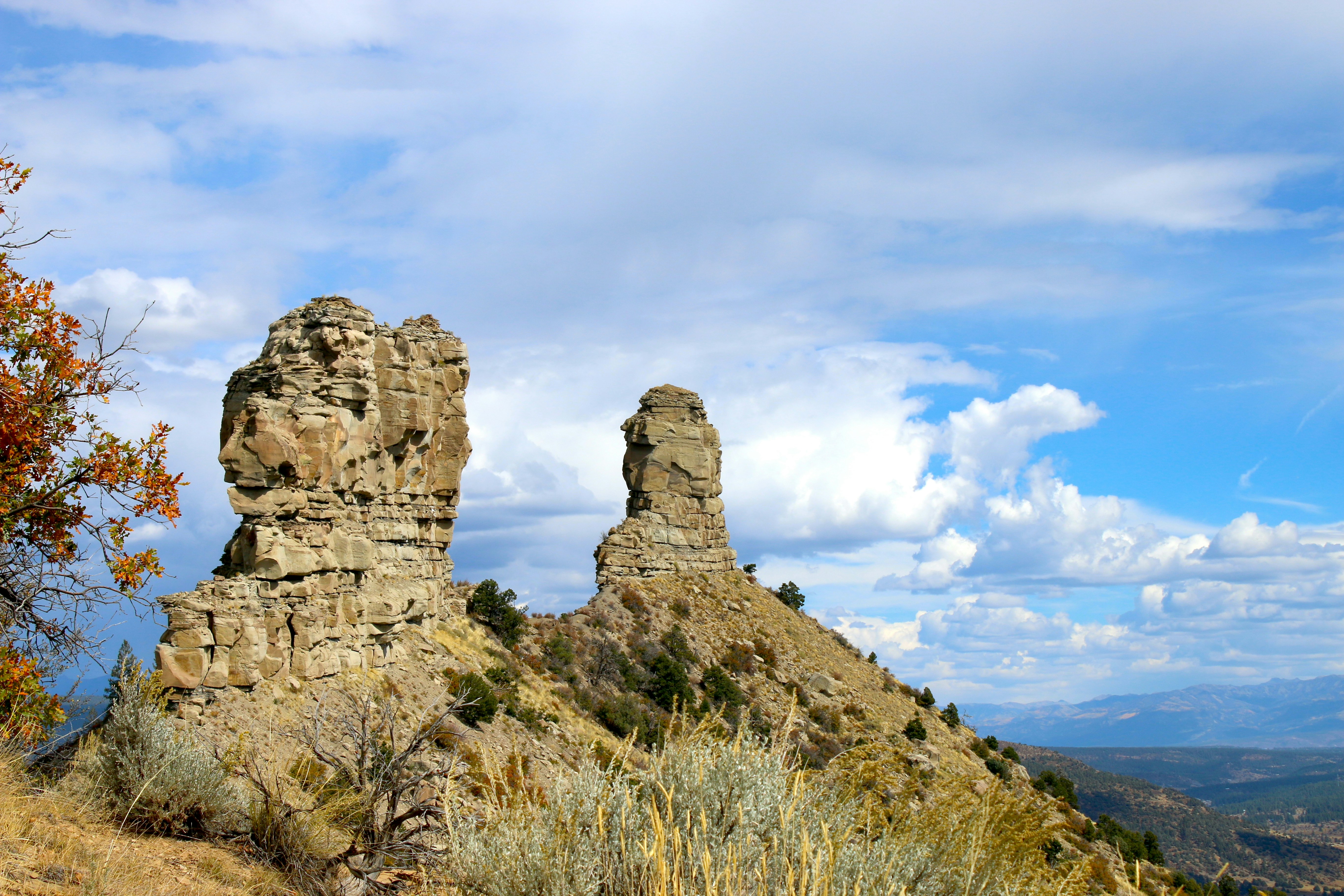 a couple of large rocks sitting on top of a hill