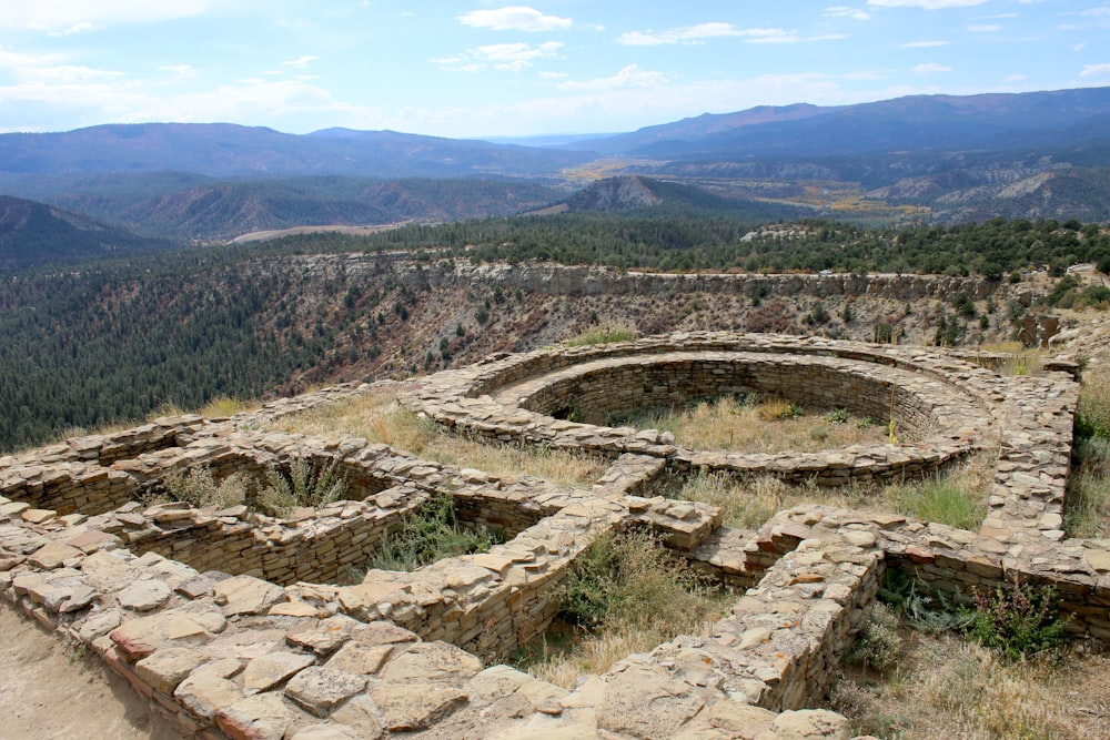 a stone structure in the middle of a mountain range