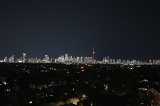 Evening cityscape showing lit residential towers