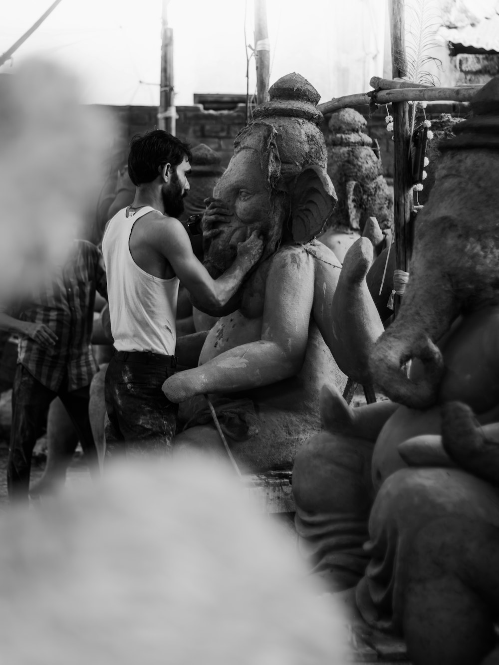 a group of people standing around a statue