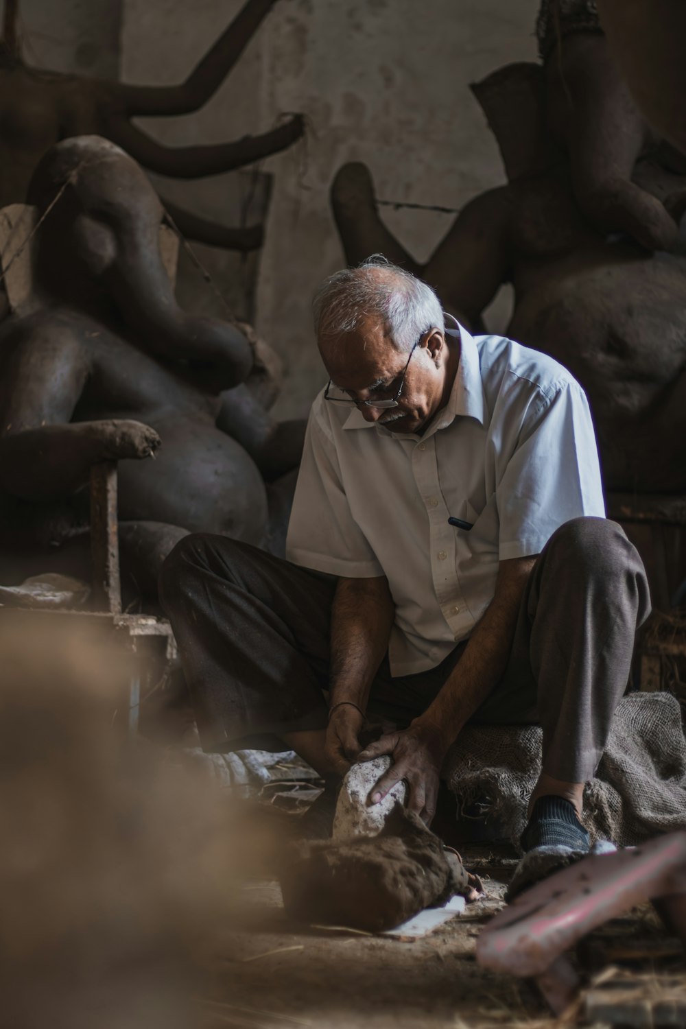 a man is working on a sculpture in a workshop