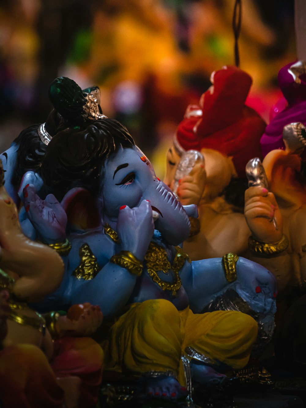 a group of small figurines of hindu deities