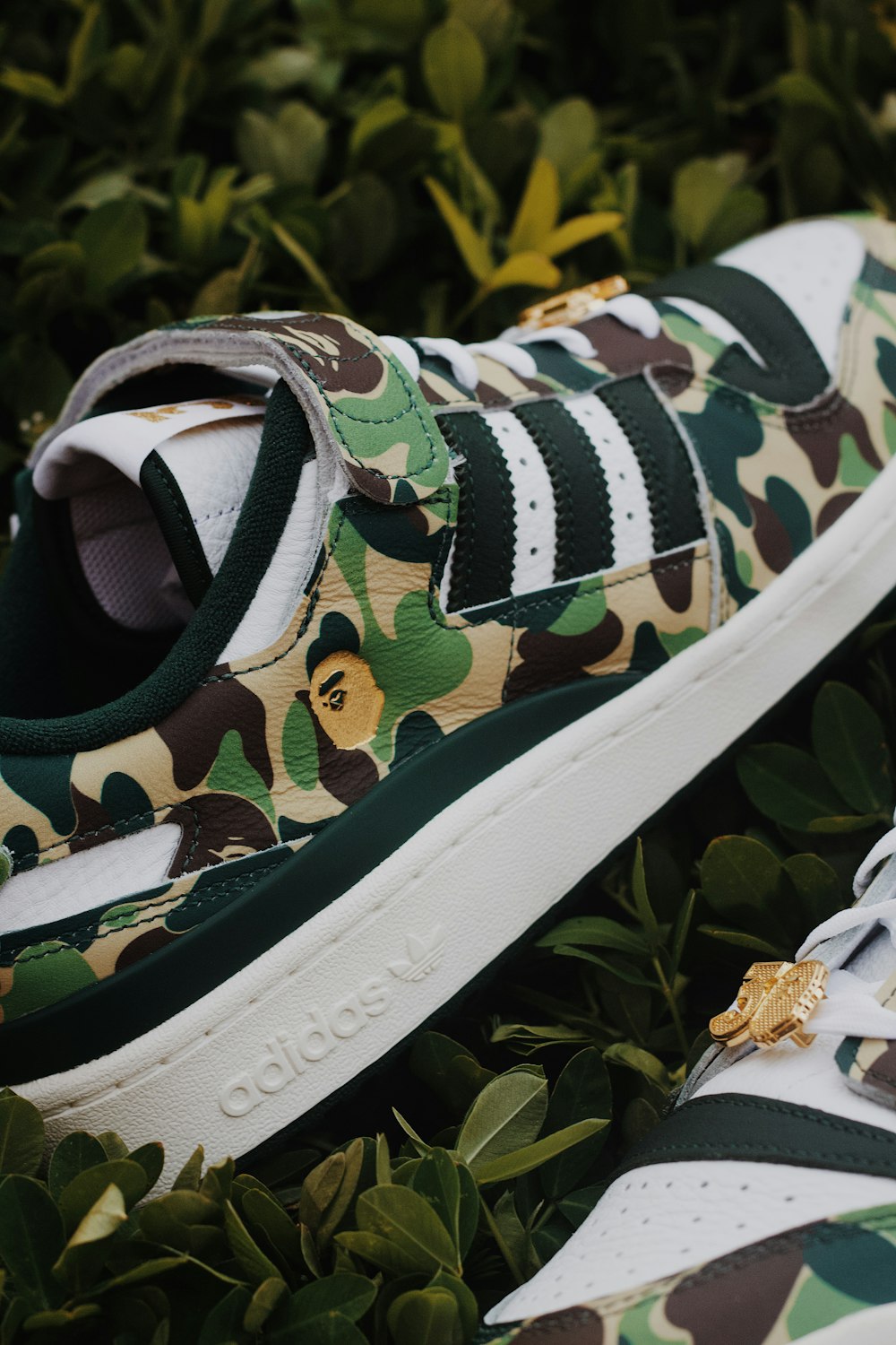 a pair of sneakers with camouflage print on them