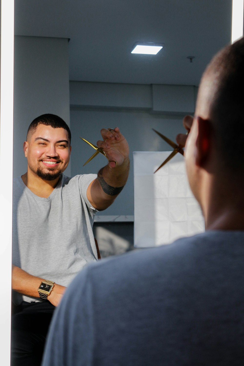 a man holding a pair of scissors in front of his face