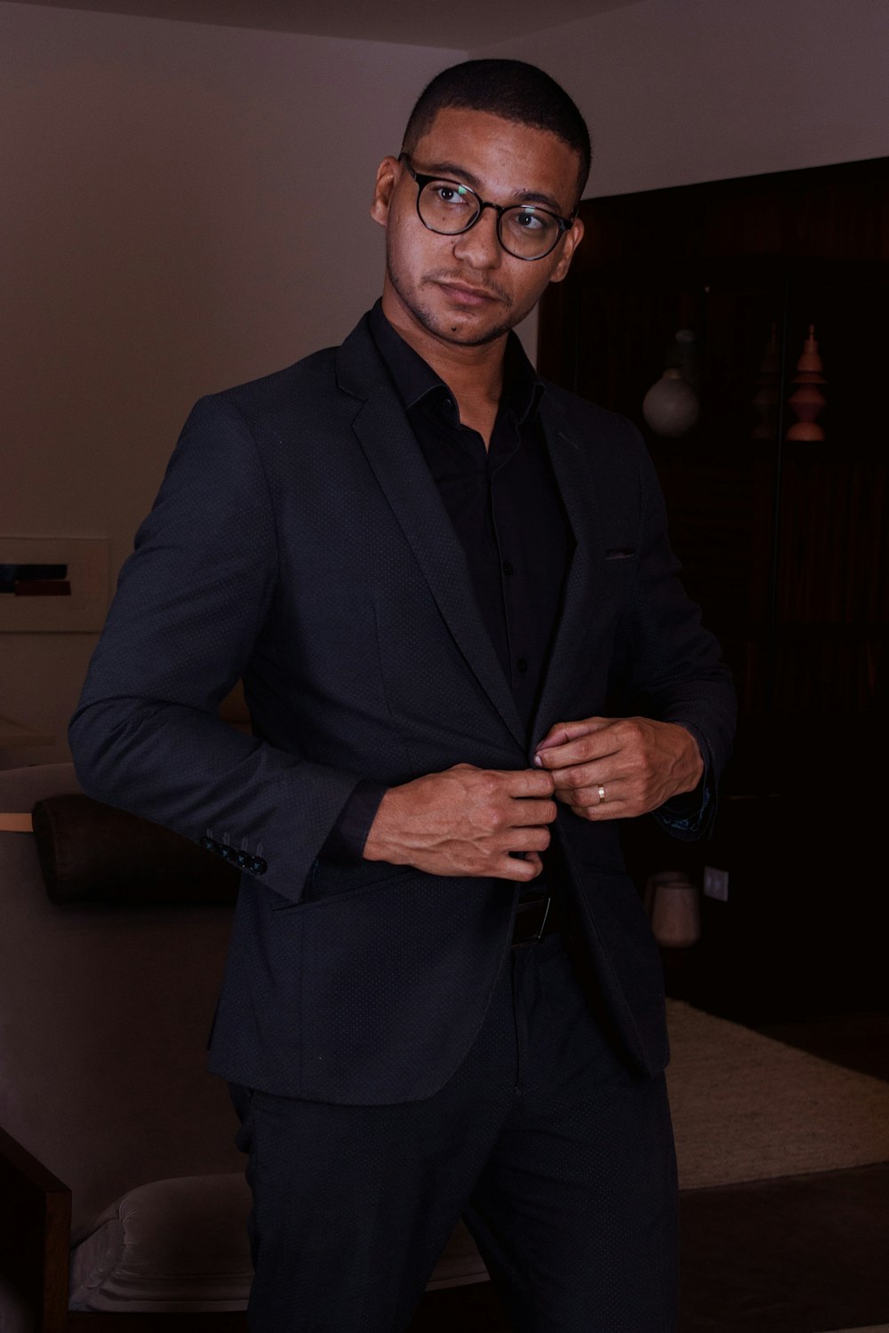 a man in a suit and glasses posing for a picture