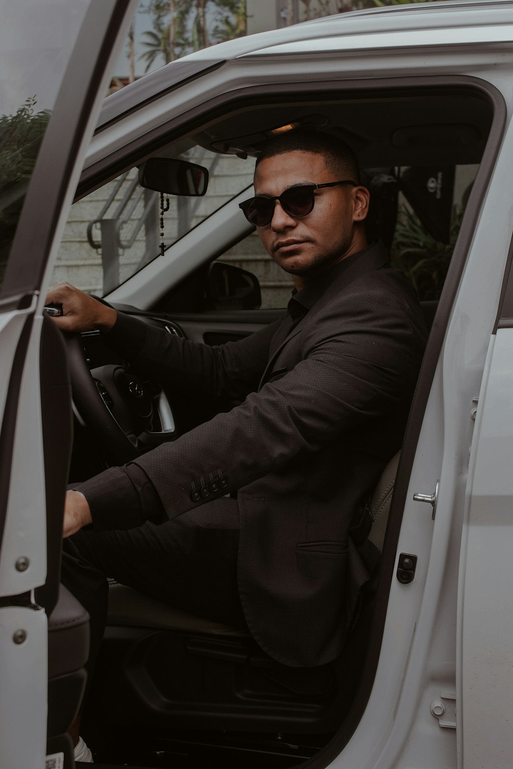 a man sitting in the driver's seat of a white van