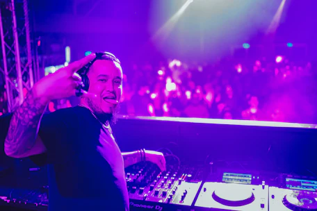 DJ Al Randall behind the microphone, smiling warmly during a live broadcast.