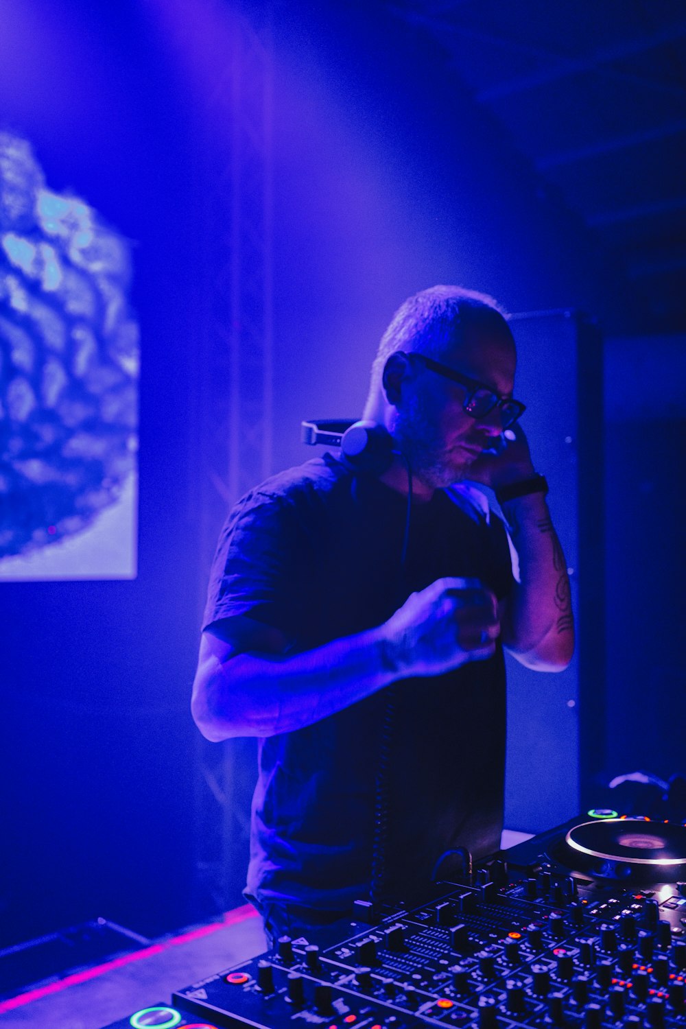 a man standing in front of a mixing desk