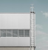 a tall white building with a clock on it's side