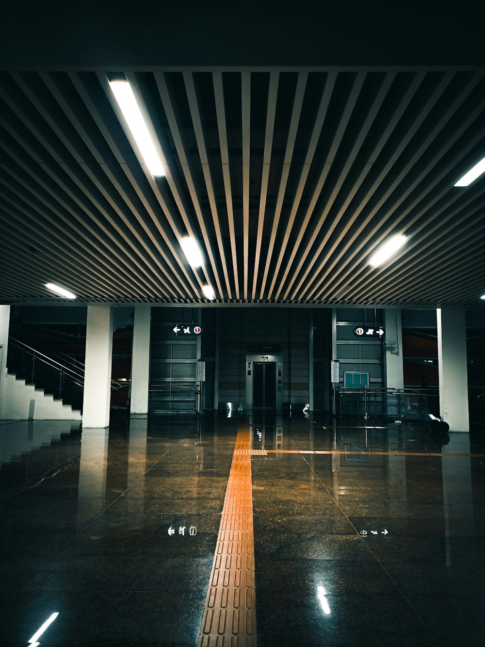 an empty room with a wooden ceiling and tiled floor