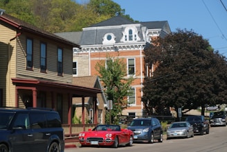 a row of cars parked on the side of a road