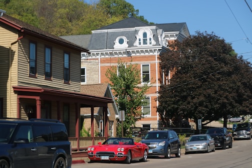 a row of cars parked on the side of a road