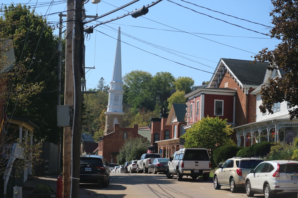 a city street with a church steeple in the background