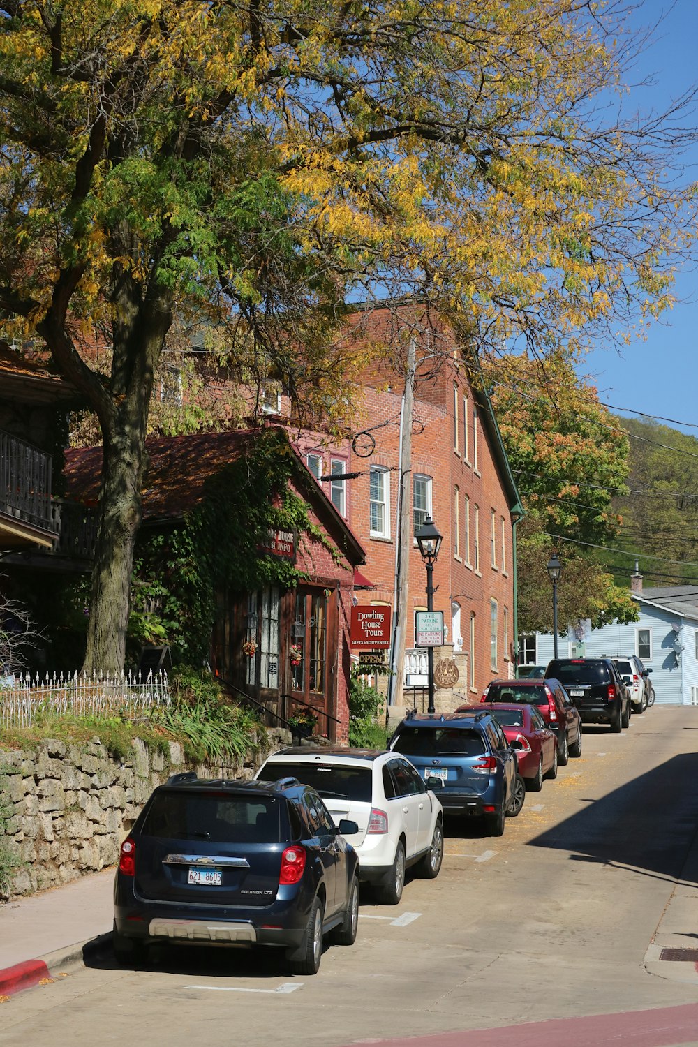 a row of cars parked on the side of a road