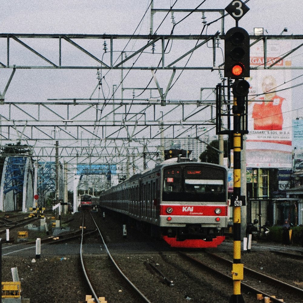 a train traveling down train tracks next to a traffic light