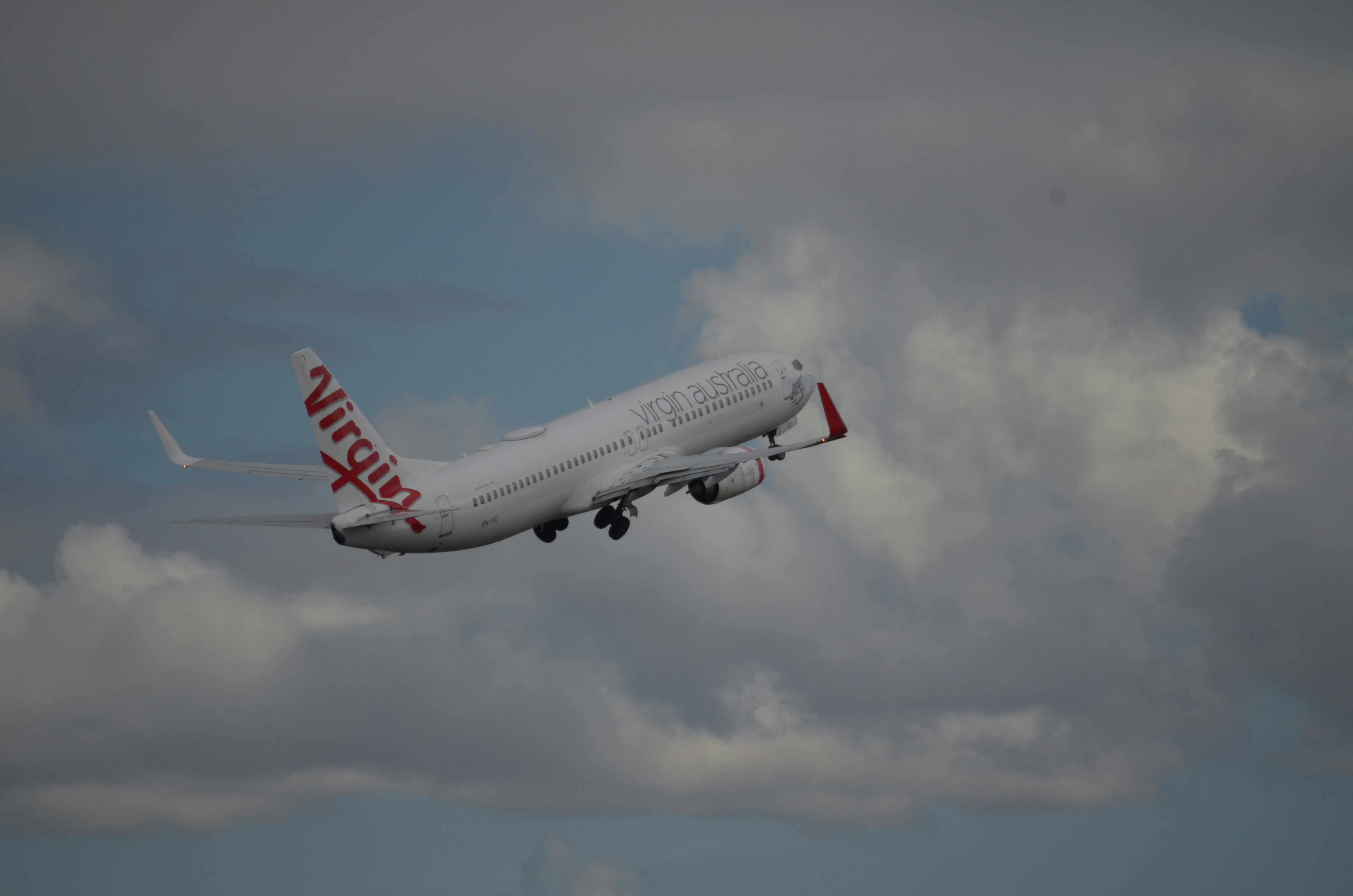 a large passenger jet flying through a cloudy sky