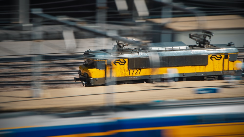 a yellow and black train traveling down train tracks