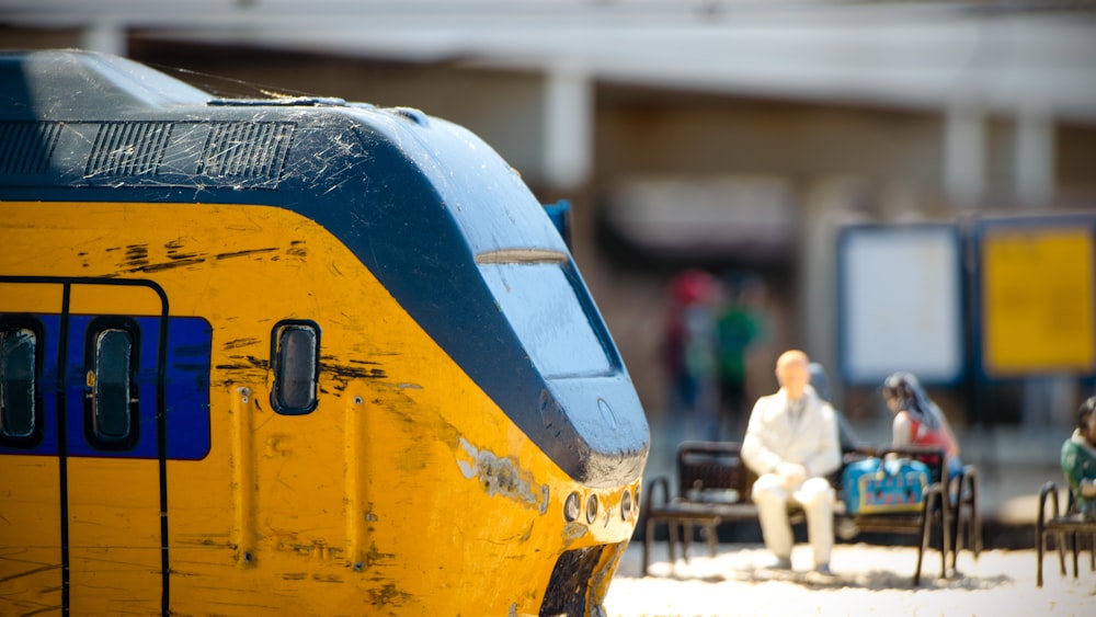 a yellow and blue train traveling down train tracks