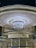 A blurred motion capture of a spinning carousel, with a glowing, luminous appearance. The structure appears to emit a warm light with circular patterns, and dense lines of light radiate outward, creating a dynamic, energetic effect.