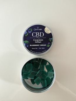A vibrant image of Thrive Botanicals CBD gummies in a strawberry flavor with fresh strawberries.