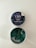A tin of CBD gummies labeled 'Blueberry Dream' with an open lid revealing square-shaped green gummies inside. The label indicates it contains 25mg of CBD and is THC free. The tin has a dark blue label with images of blueberries and leaves.