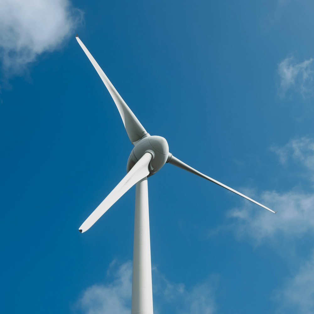 a wind turbine with a blue sky in the background