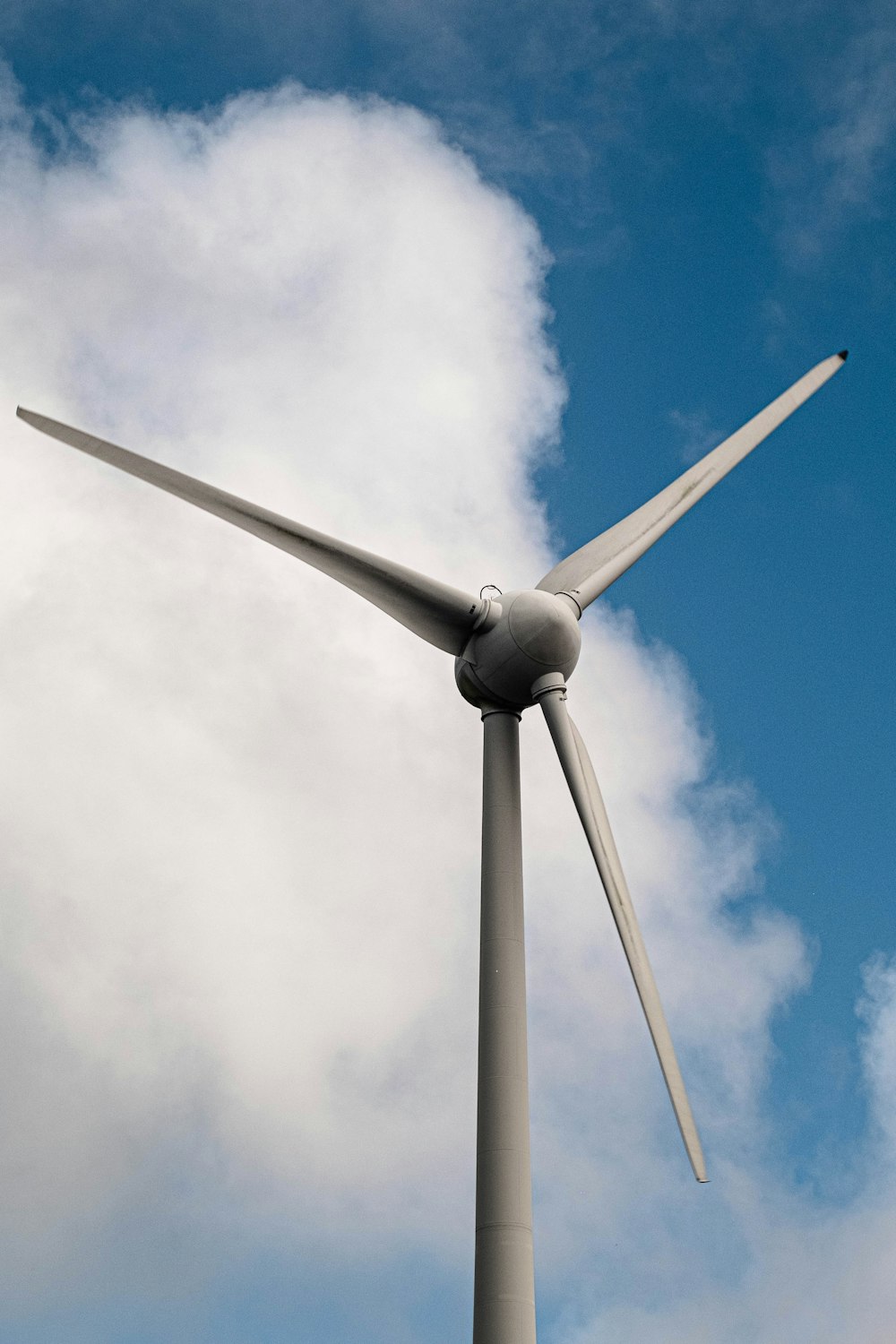 a wind turbine with a blue sky in the background