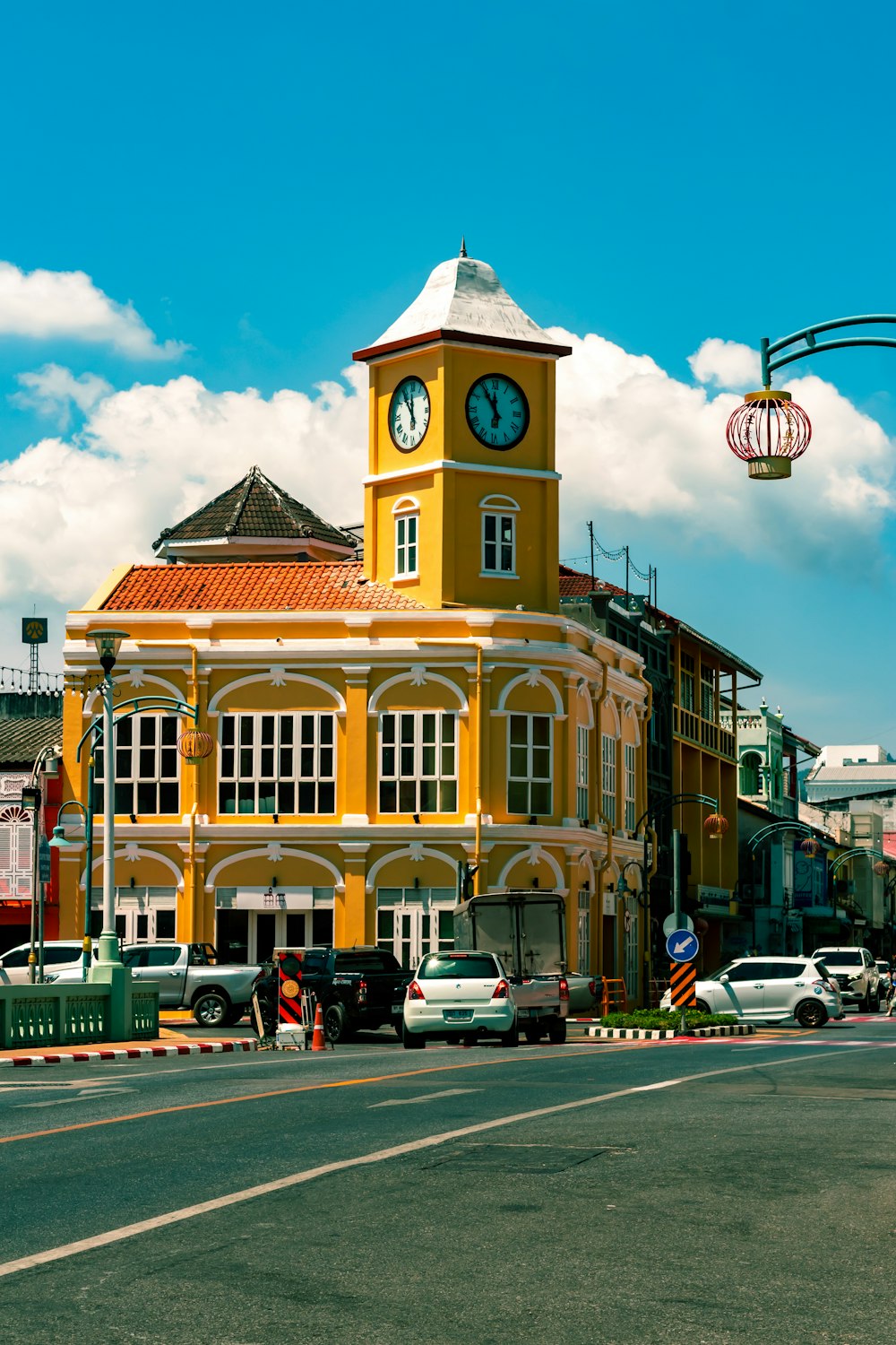 a yellow building with a clock on the top of it