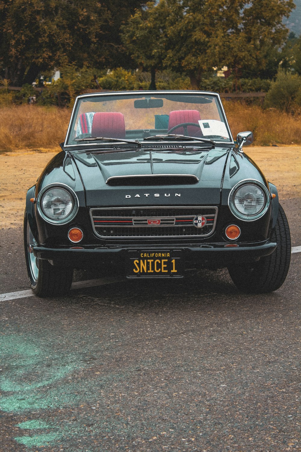 a black convertible car parked in a parking lot