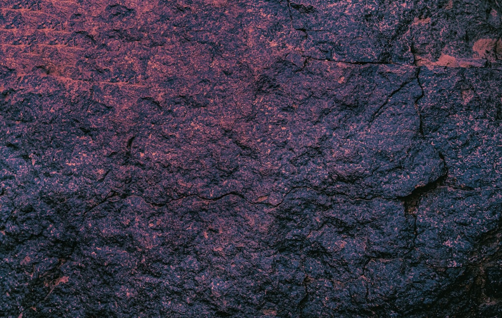 a close up of a rock with a red light in the background