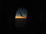 A peaceful sunset view from an airplane window during flight.