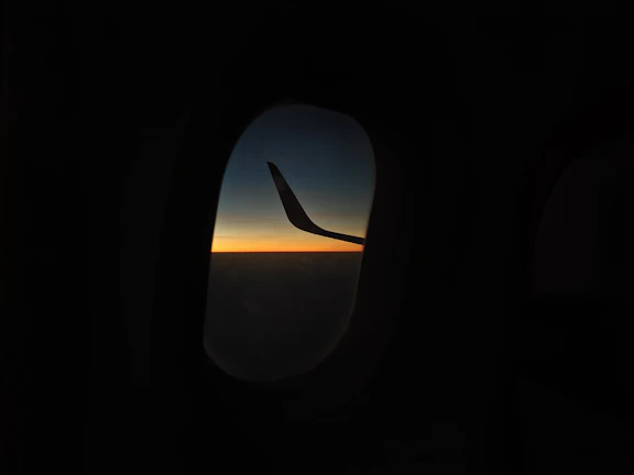 A peaceful sunset view from an airplane window during flight.