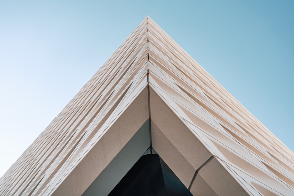 a triangular building with a sky background