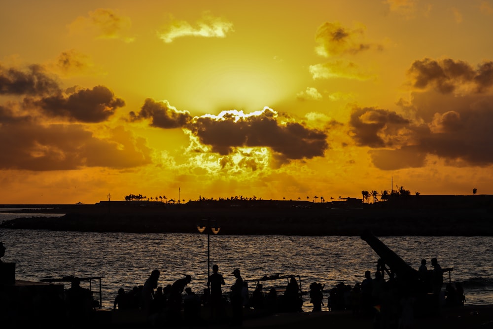 a large body of water with a sun in the background