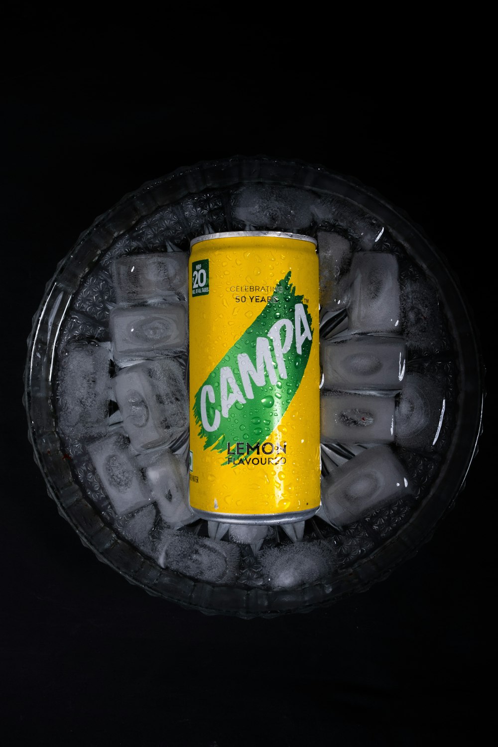 a can of campa beer sitting on top of ice cubes