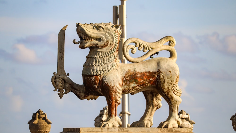 a statue of a lion holding a sword