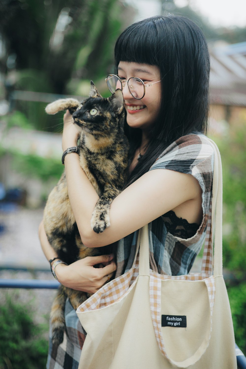 a woman holding a cat in her arms