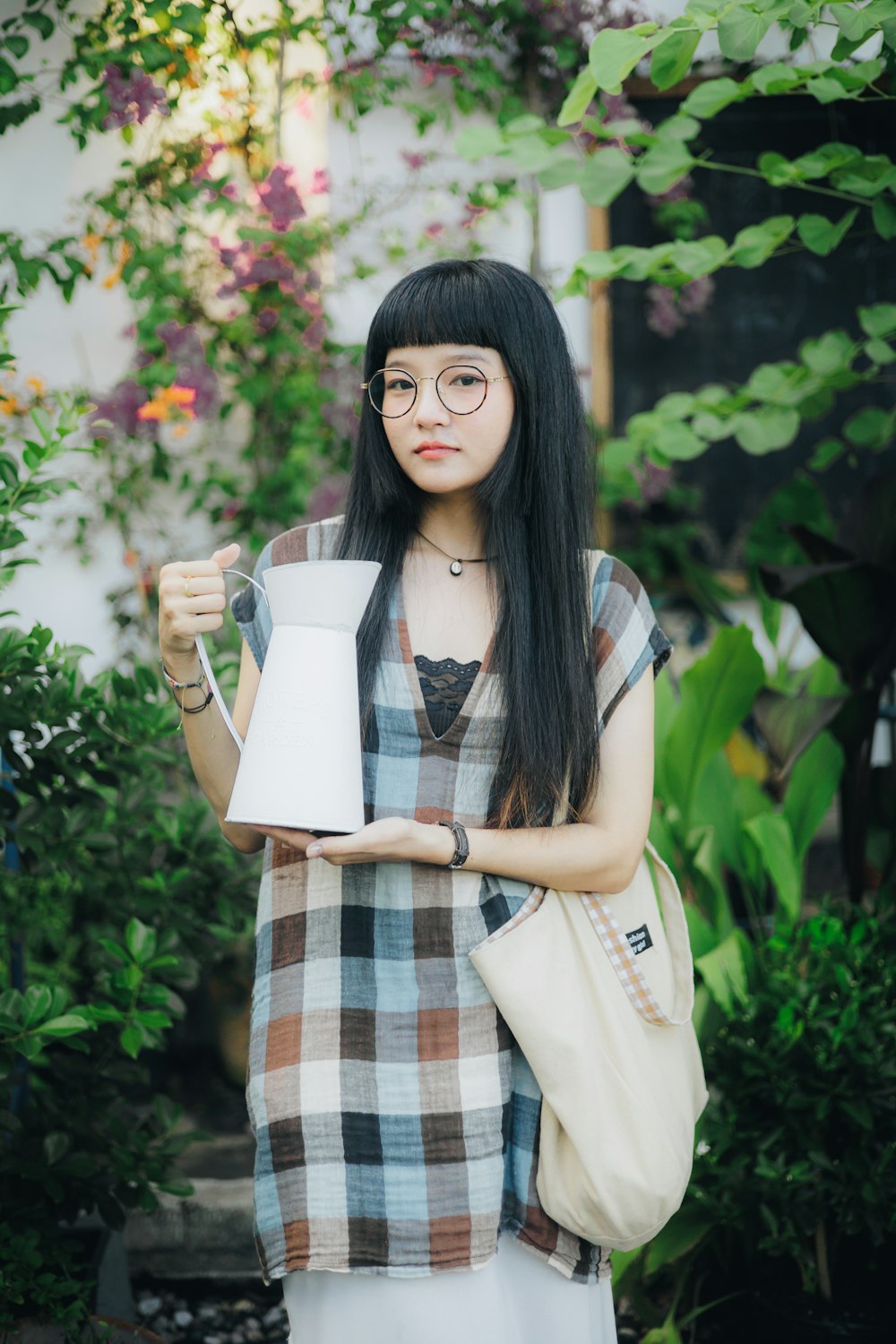 a woman holding a cup and a book in her hands