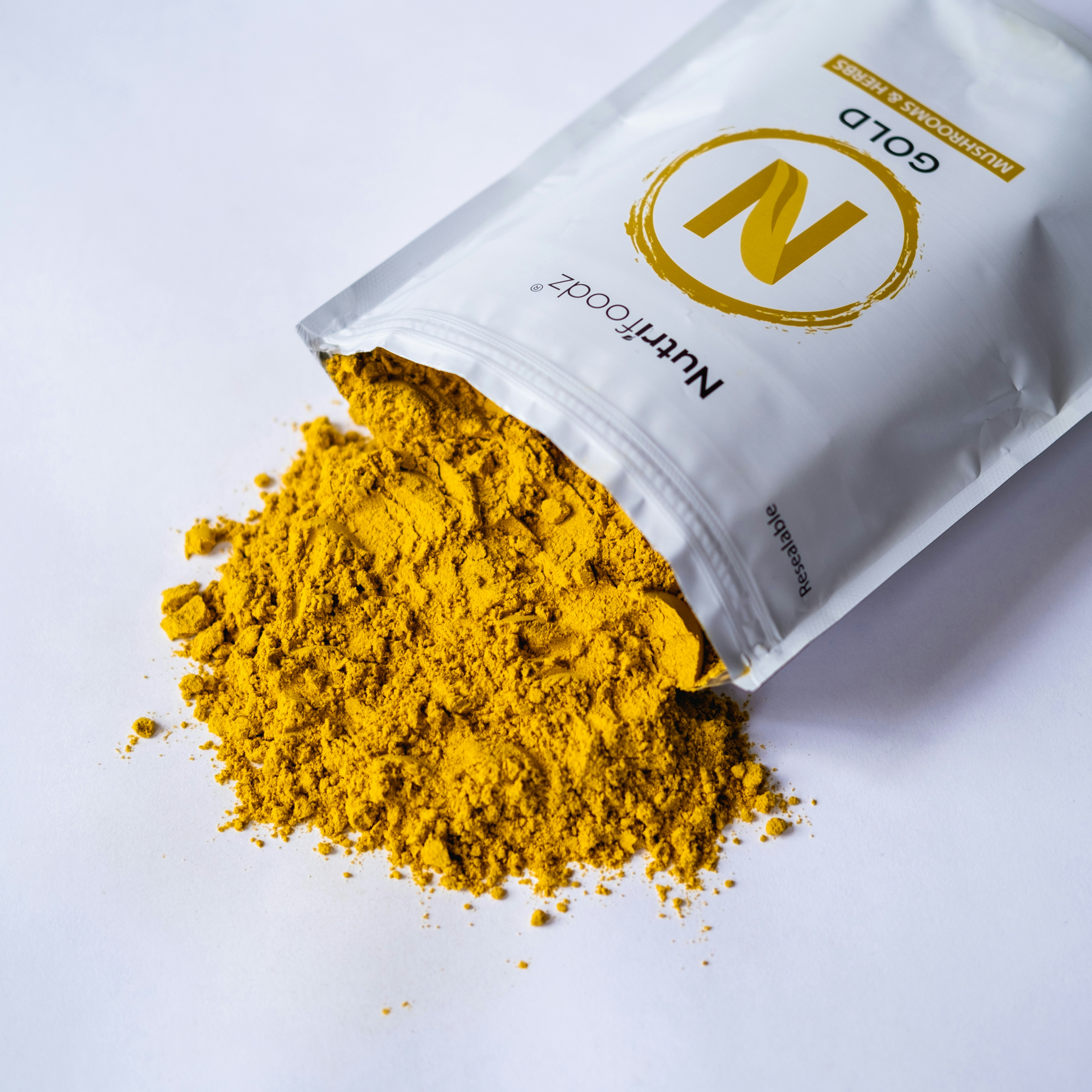 a bag of yellow powder sitting on top of a white table