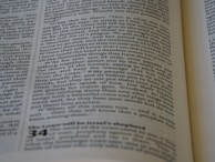 A close-up of a page from a book, featuring printed text in columns. The text is aligned and appears to be extracted from a religious or philosophical context.