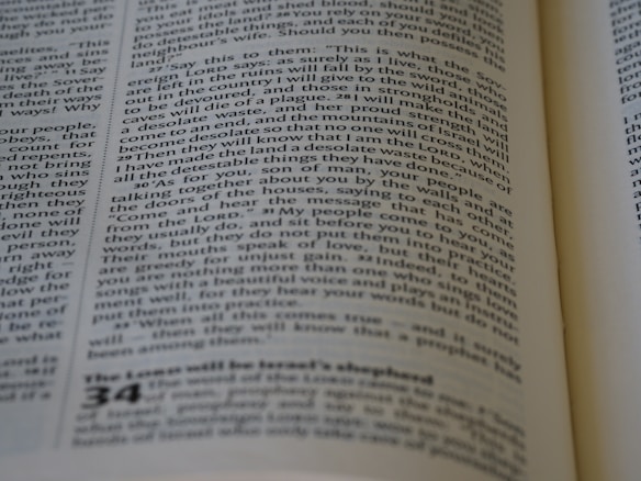 A close-up of a page from a book, featuring printed text in columns. The text is aligned and appears to be extracted from a religious or philosophical context.