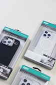Several ESR brand phone cases in various packaging designs, including a soft case, a clear case, and a tempered glass case, displayed on a light surface.