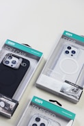 Several ESR brand phone cases in various packaging designs, including a soft case, a clear case, and a tempered glass case, displayed on a light surface.