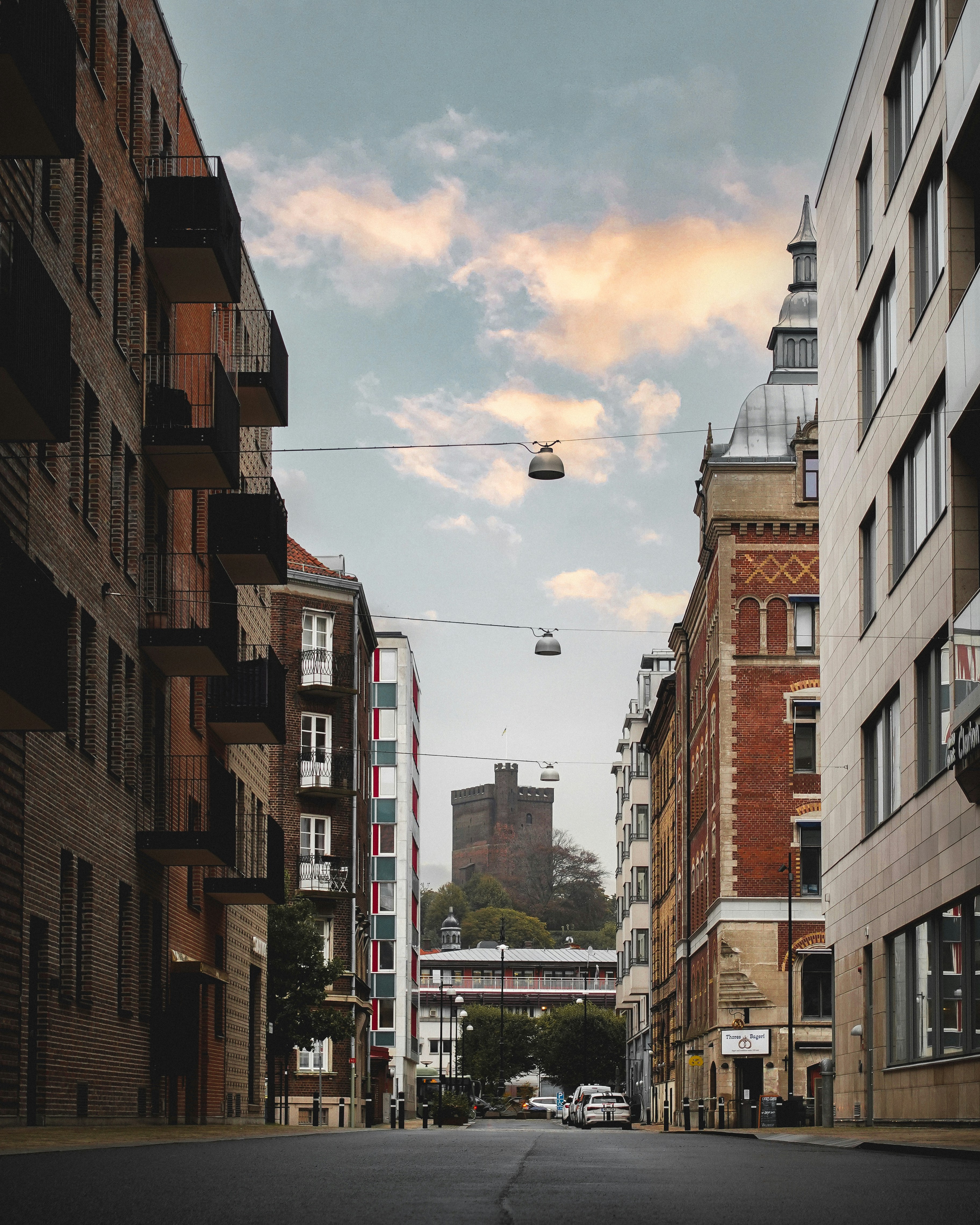 a view of a street in a city with tall buildings