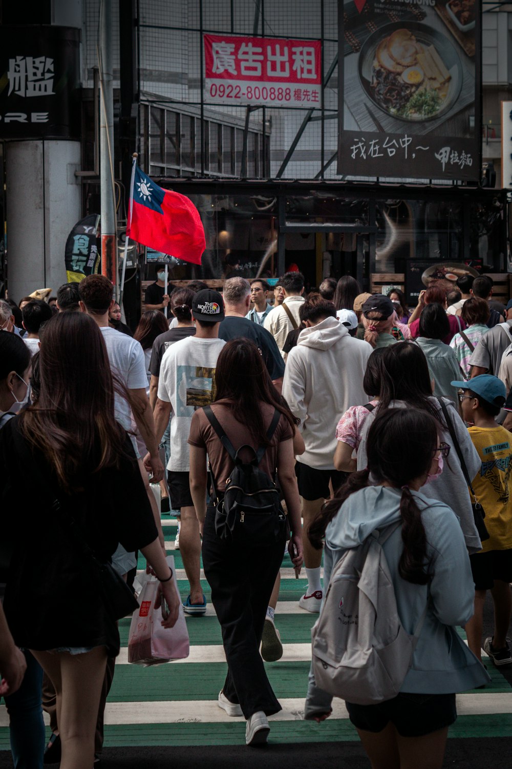 a crowd of people walking across a street