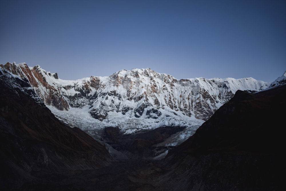 a snow covered mountain is seen in the distance