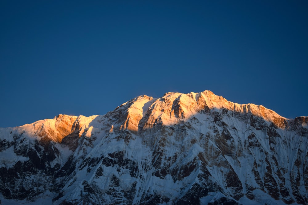 the top of a mountain with snow on it