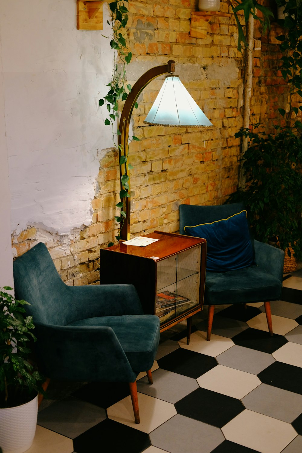 a living room with two chairs and a lamp