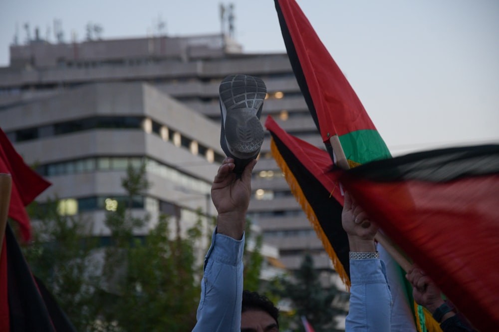 a group of people holding flags and shoes