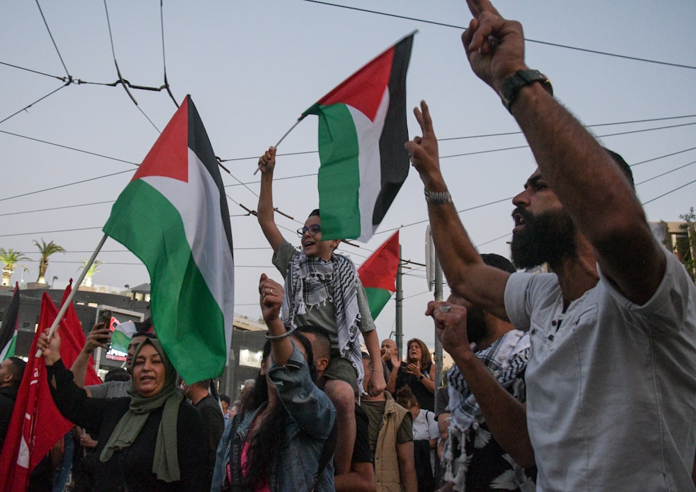 a group of people holding flags and waving